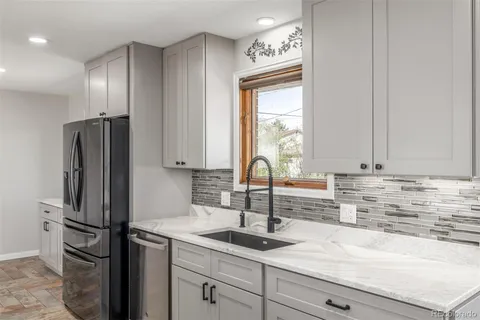 a kitchen with a refrigerator and a sink