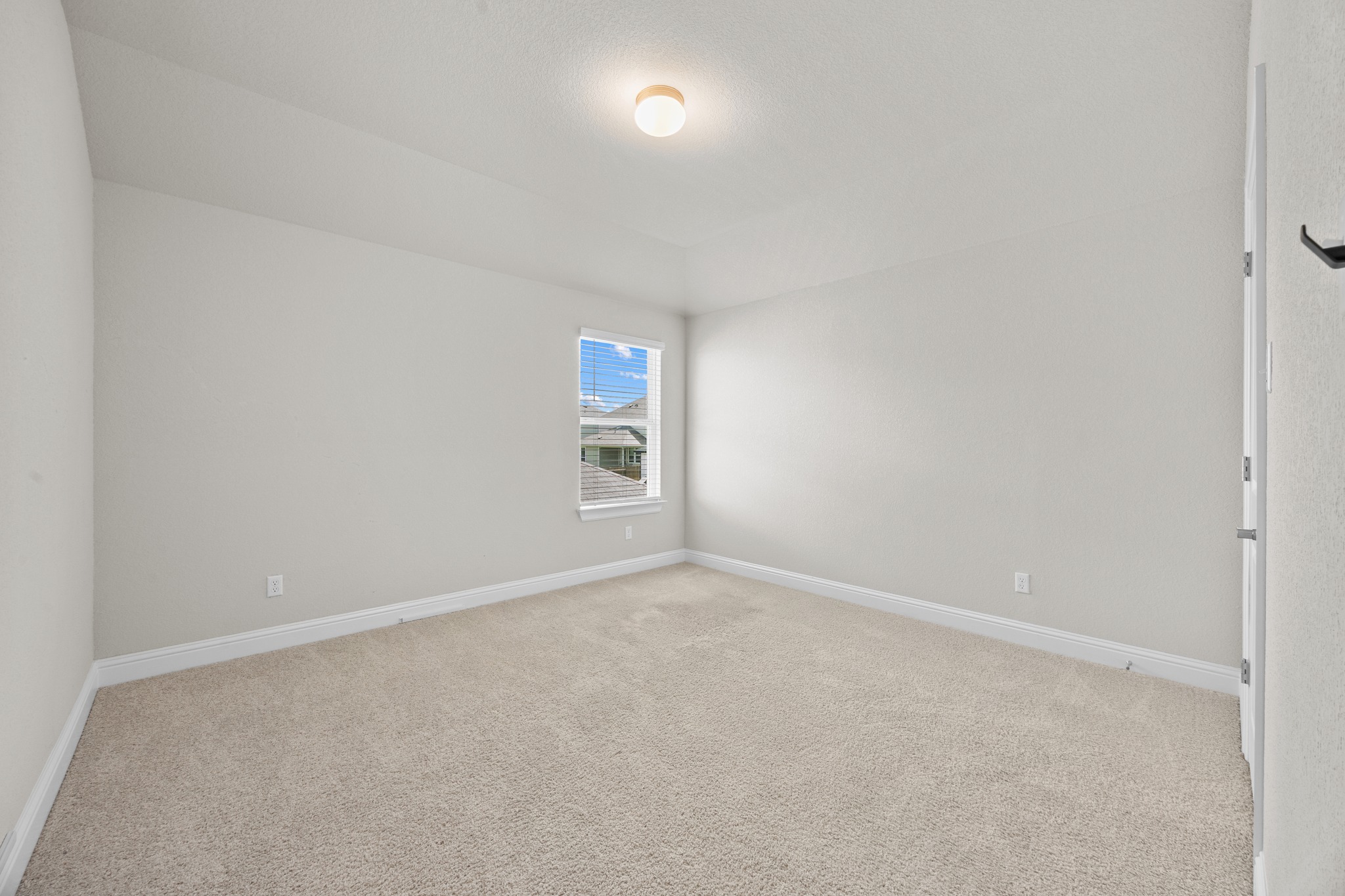 213 Graver Street Georgetown, TX 78626 - Photo 25 of 33 A well-proportioned bedroom offers new carpeting and a bright window.