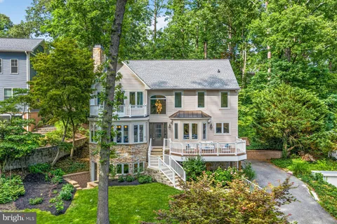 a aerial view of a house with yard and trees