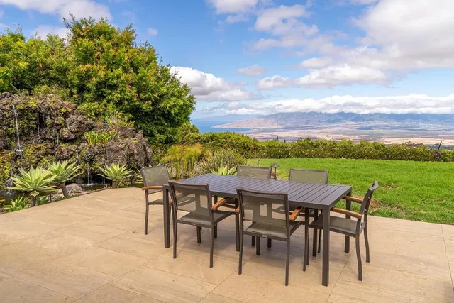 a view of an outdoor space with furniture and garden