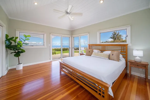a bedroom with a large bed and a chandelier