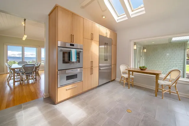 a large living room with a furniture a fireplace and a chandelier