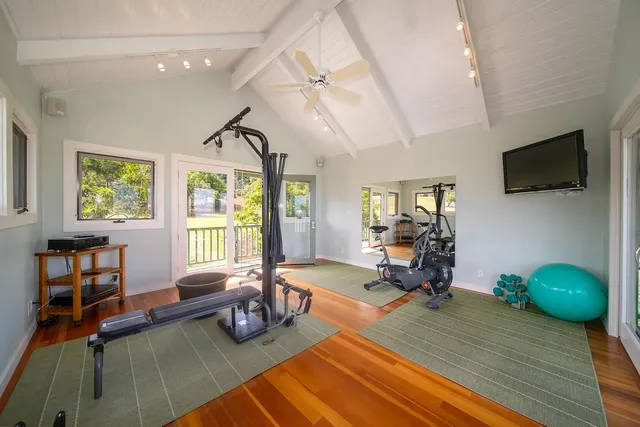 a bedroom with furniture and a flat screen tv