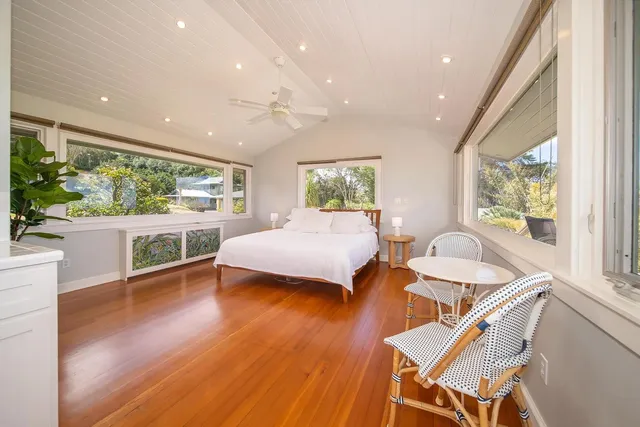 a bedroom with furniture and a large window