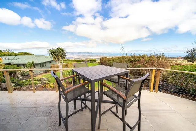 a view of a roof deck with furniture