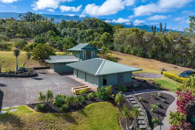 a view of a house with a yard and garden