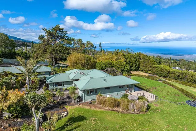 a aerial view of a house with yard swimming pool and outdoor seating
