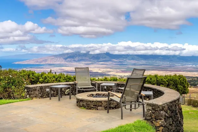 a roof deck with table and chairs