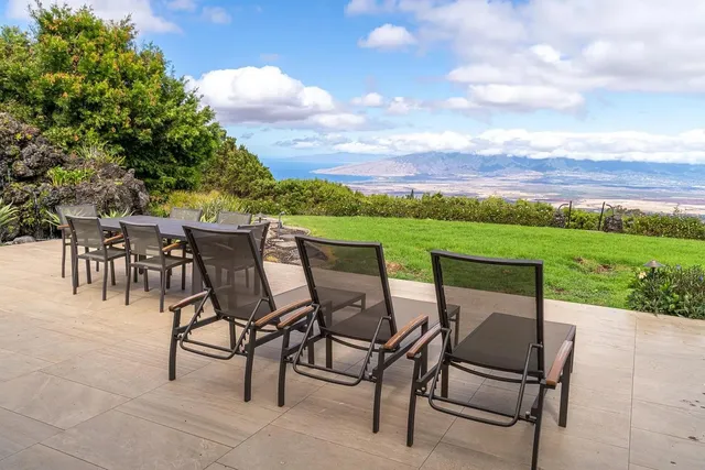 a view of a chairs and table in patio