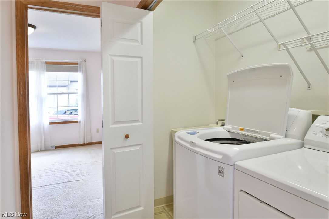 2033 East River Road, Unit 11 Newton Falls, OH 44444 - Photo 27 of 35 Clothes washing area with light carpet and washer and clothes dryer