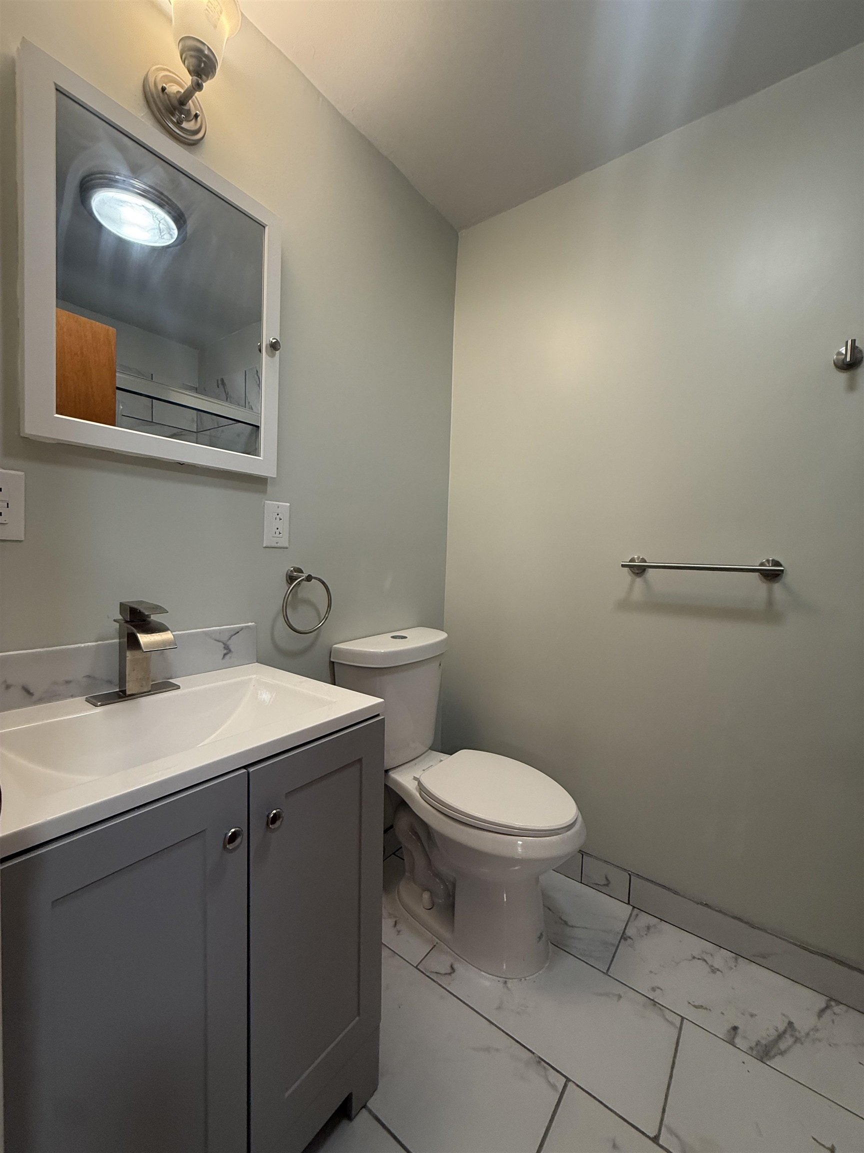 63 Prospect Avenue, Unit 2 Bayonne, NJ 07002 - Photo 13 of 14 a bathroom with a sink and a toilet