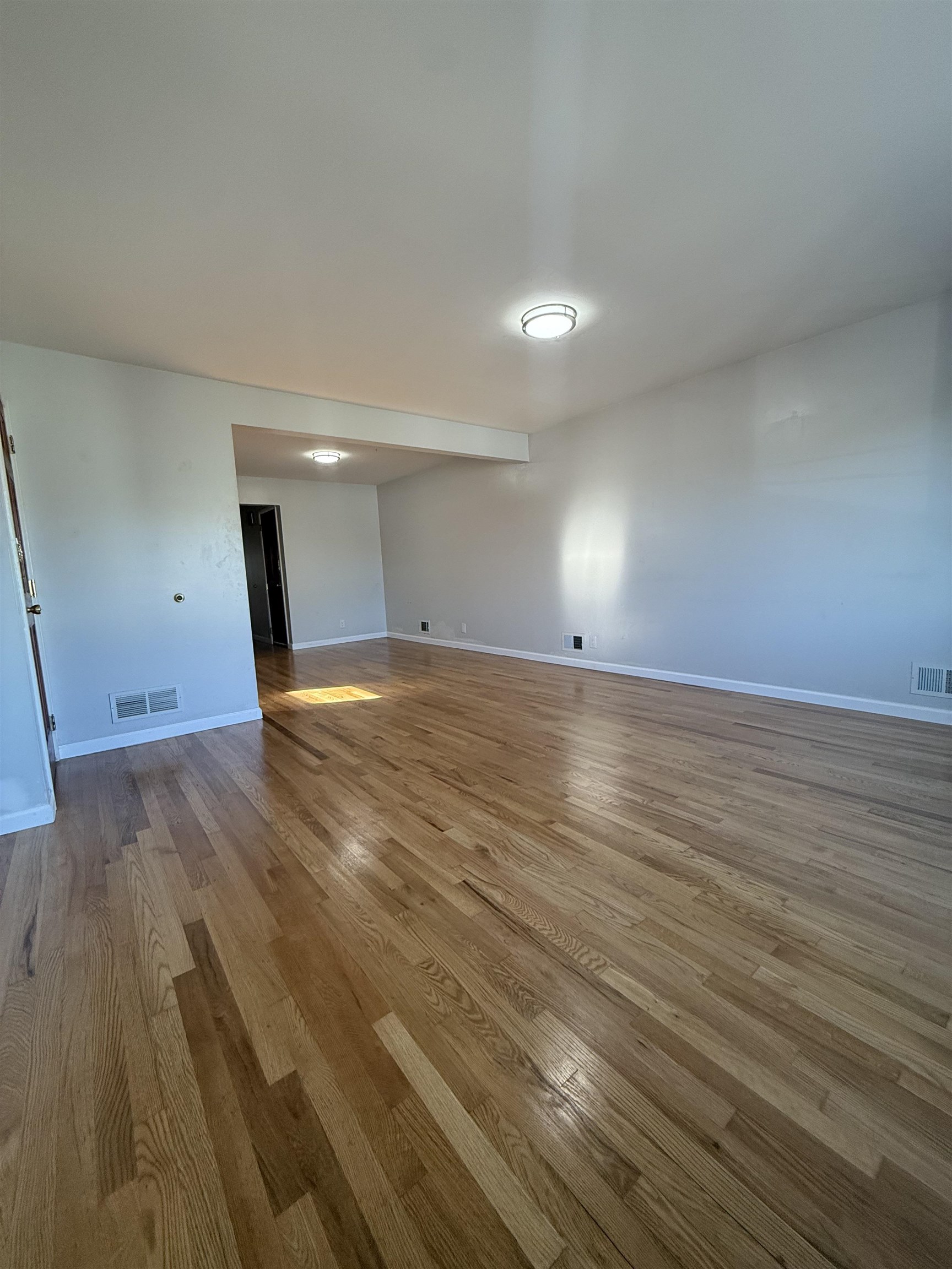 63 Prospect Avenue, Unit 2 Bayonne, NJ 07002 - Photo 4 of 14 a view of an empty room with wooden floor