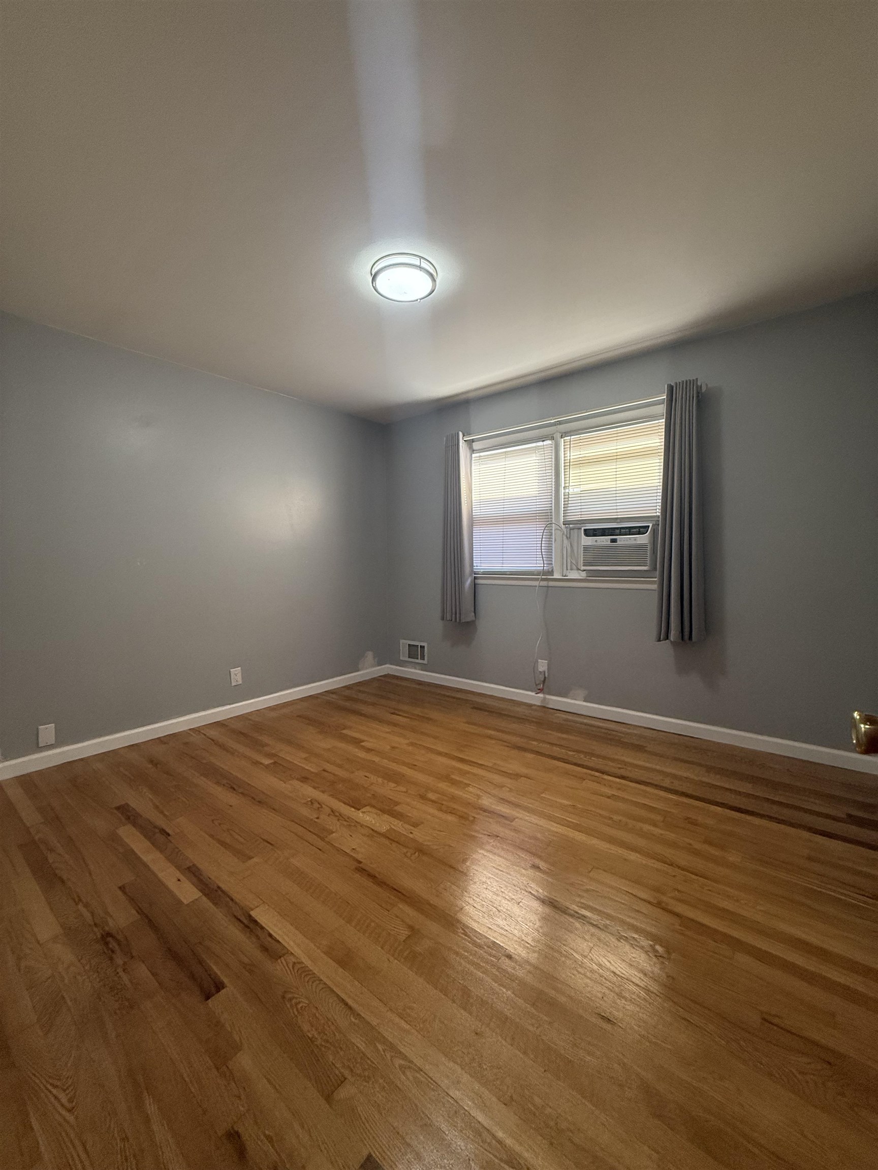 63 Prospect Avenue, Unit 2 Bayonne, NJ 07002 - Photo 7 of 14 a view of empty room with wooden floor and fan