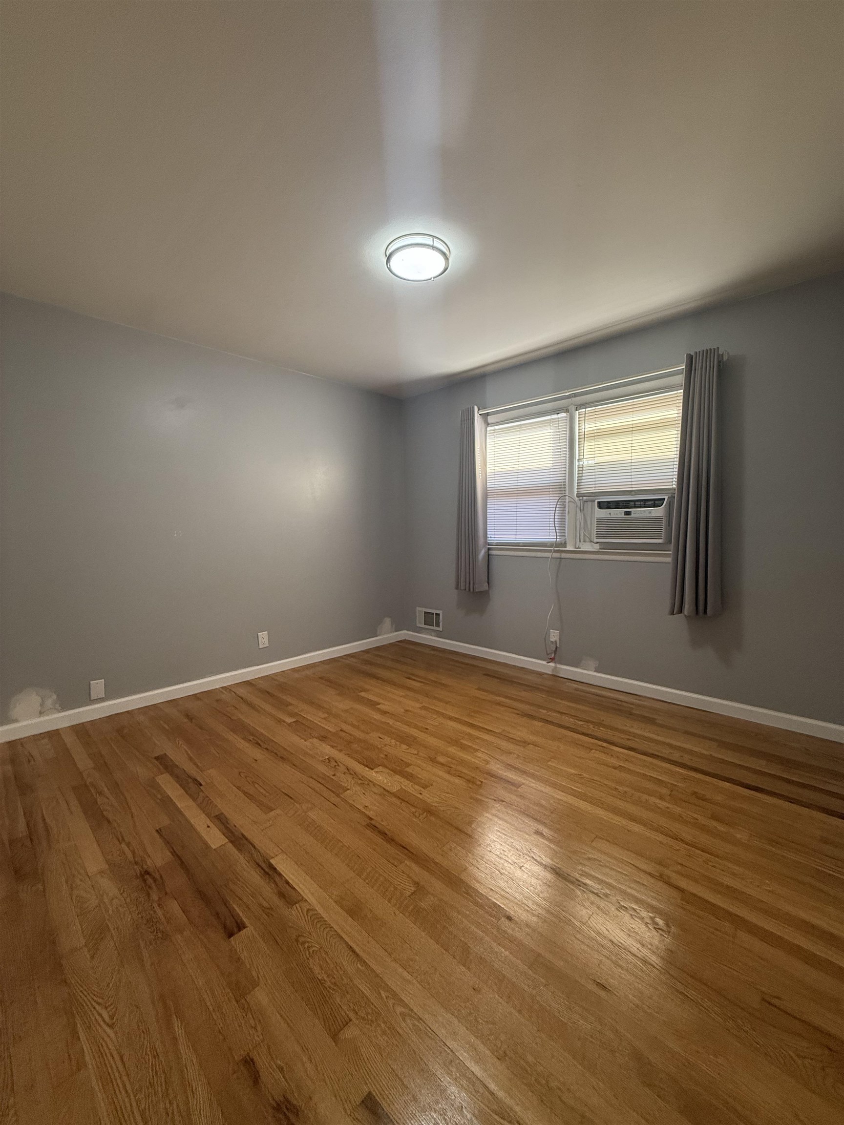63 Prospect Avenue, Unit 2 Bayonne, NJ 07002 - Photo 8 of 14 a view of empty room with wooden floor and fan