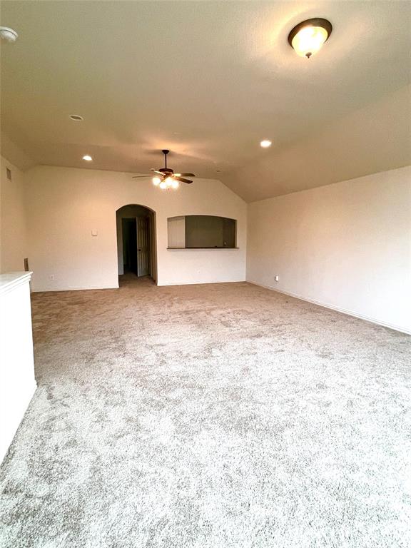 5412 Bentrose Drive McKinney, TX 75070 - Photo 14 of 24 an empty room with kitchen view and a fireplace