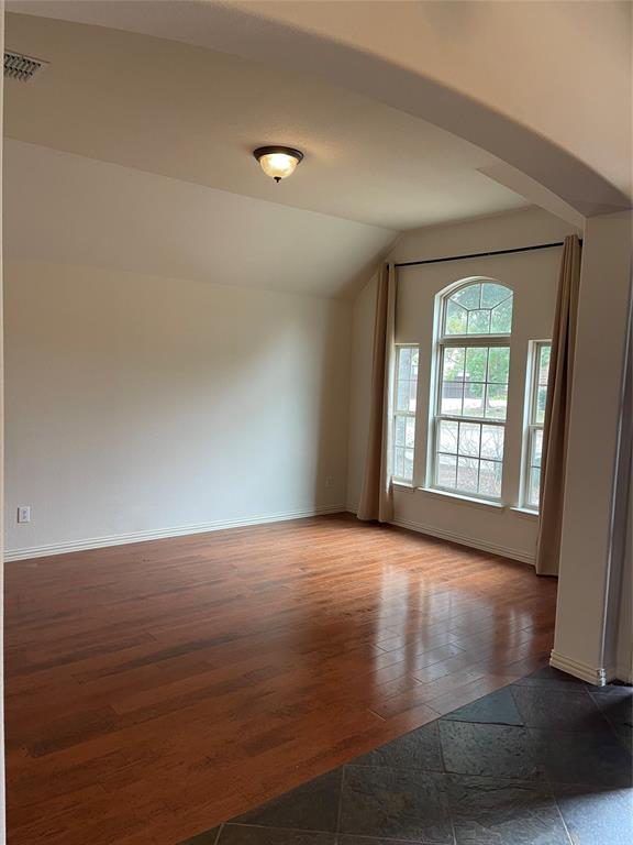 5412 Bentrose Drive McKinney, TX 75070 - Photo 3 of 24 a view of an empty room with wooden floor and a window