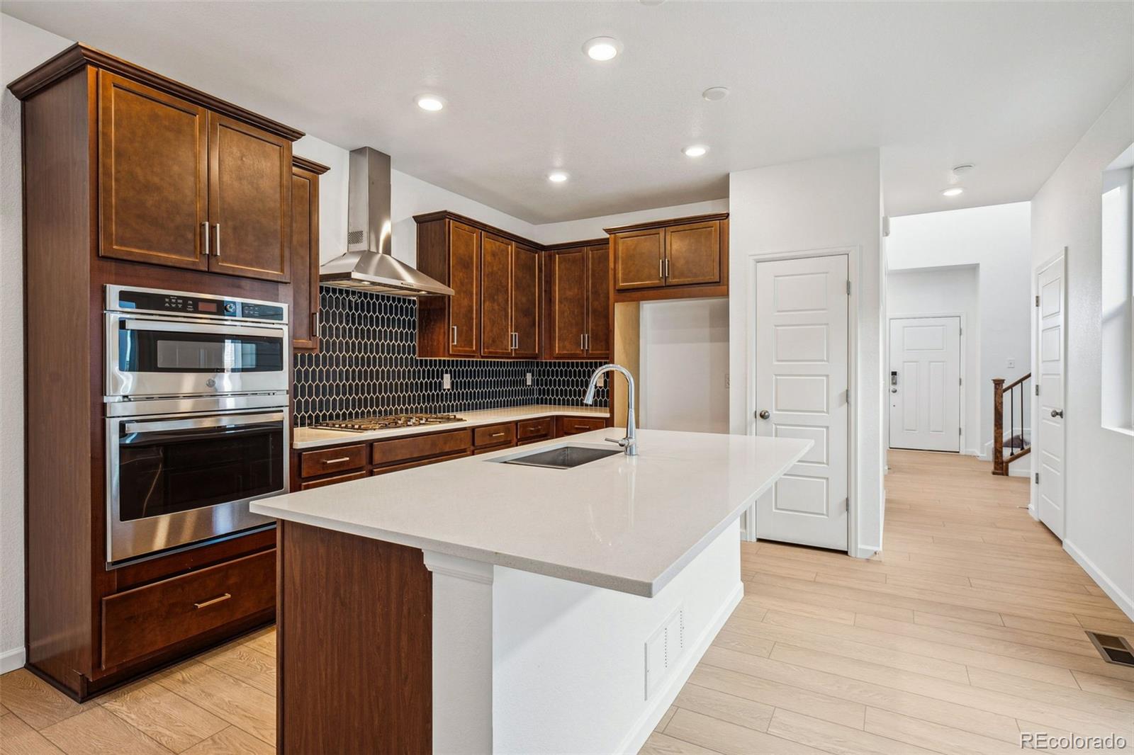 2068 Chambers Road Brighton, CO 80601 - Photo 2 of 27 a kitchen with stainless steel appliances kitchen island granite countertop a refrigerator and a sink