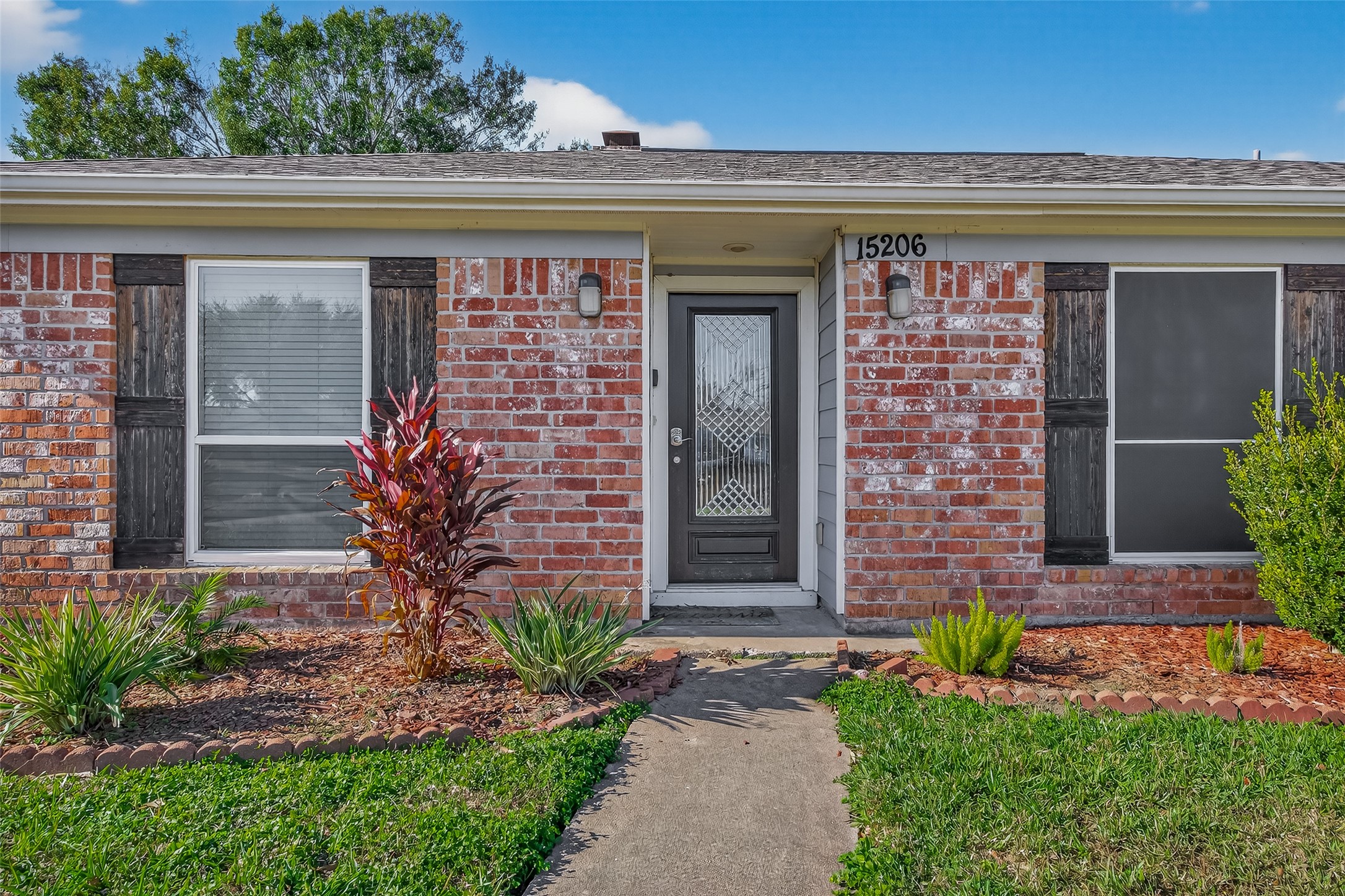 15206 Ridingwood Drive Houston, TX 77489 - Photo 3 of 43 a front view of a house with plants