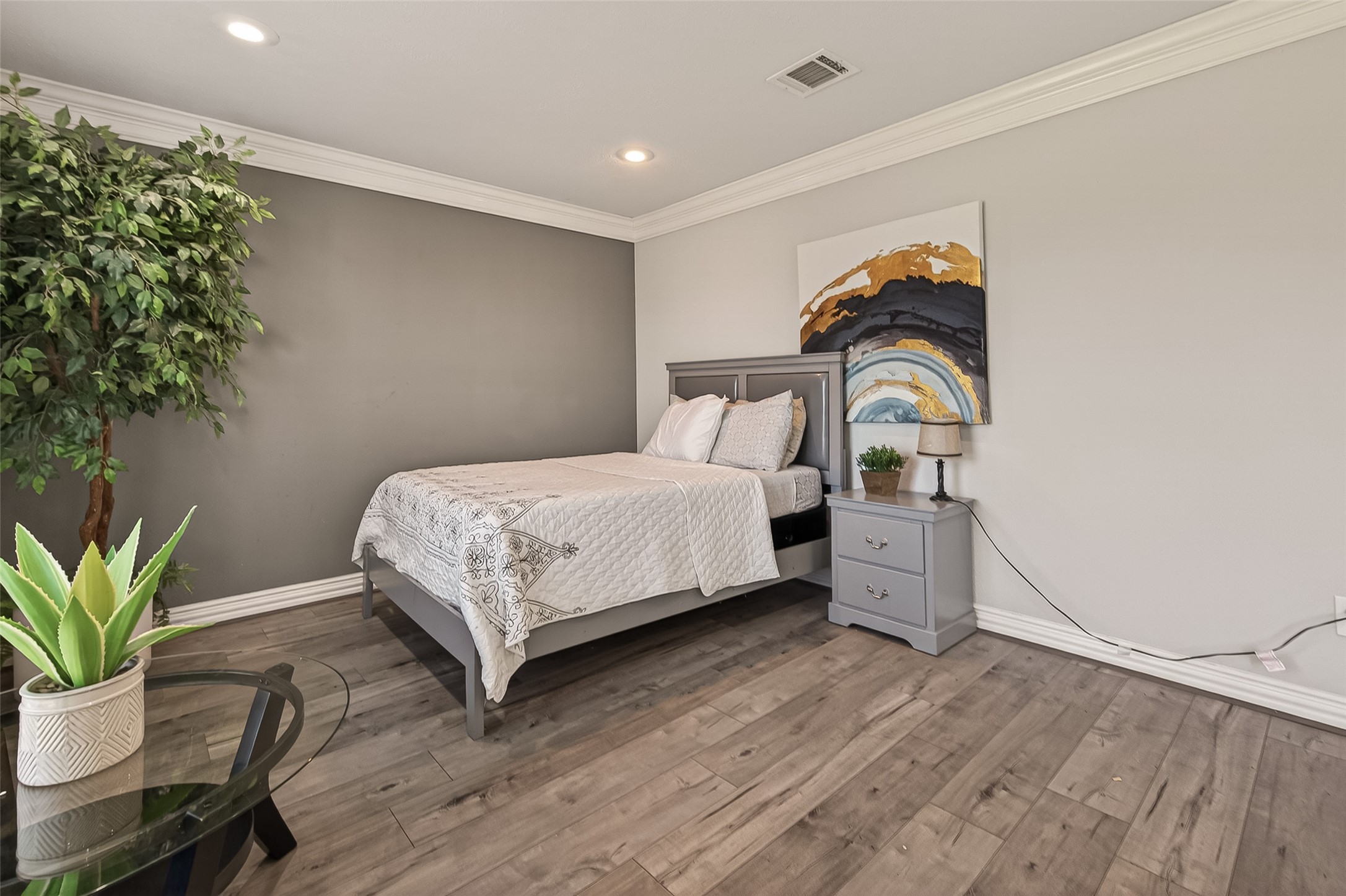 15206 Ridingwood Drive Houston, TX 77489 - Photo 7 of 43 a bedroom with a bed and a potted plant