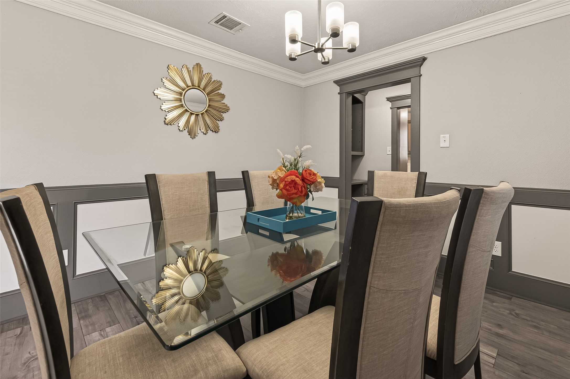 15206 Ridingwood Drive Houston, TX 77489 - Photo 10 of 43 a view of a dining room with furniture a chandelier and wooden floor