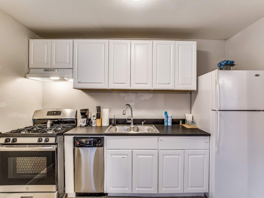 4202 Stanford Street, Unit 5 Houston, TX 77006 - Photo 1 of 7 a kitchen with stainless steel appliances granite countertop a refrigerator stove a sink and cabinets
