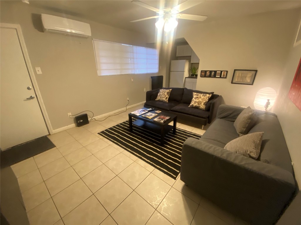 4202 Stanford Street, Unit 5 Houston, TX 77006 - Photo 4 of 7 a living room with furniture and a chandelier