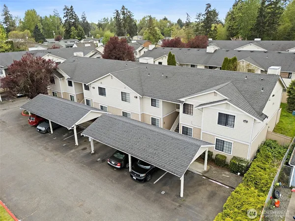 an aerial view of a house with a yard and sitting area