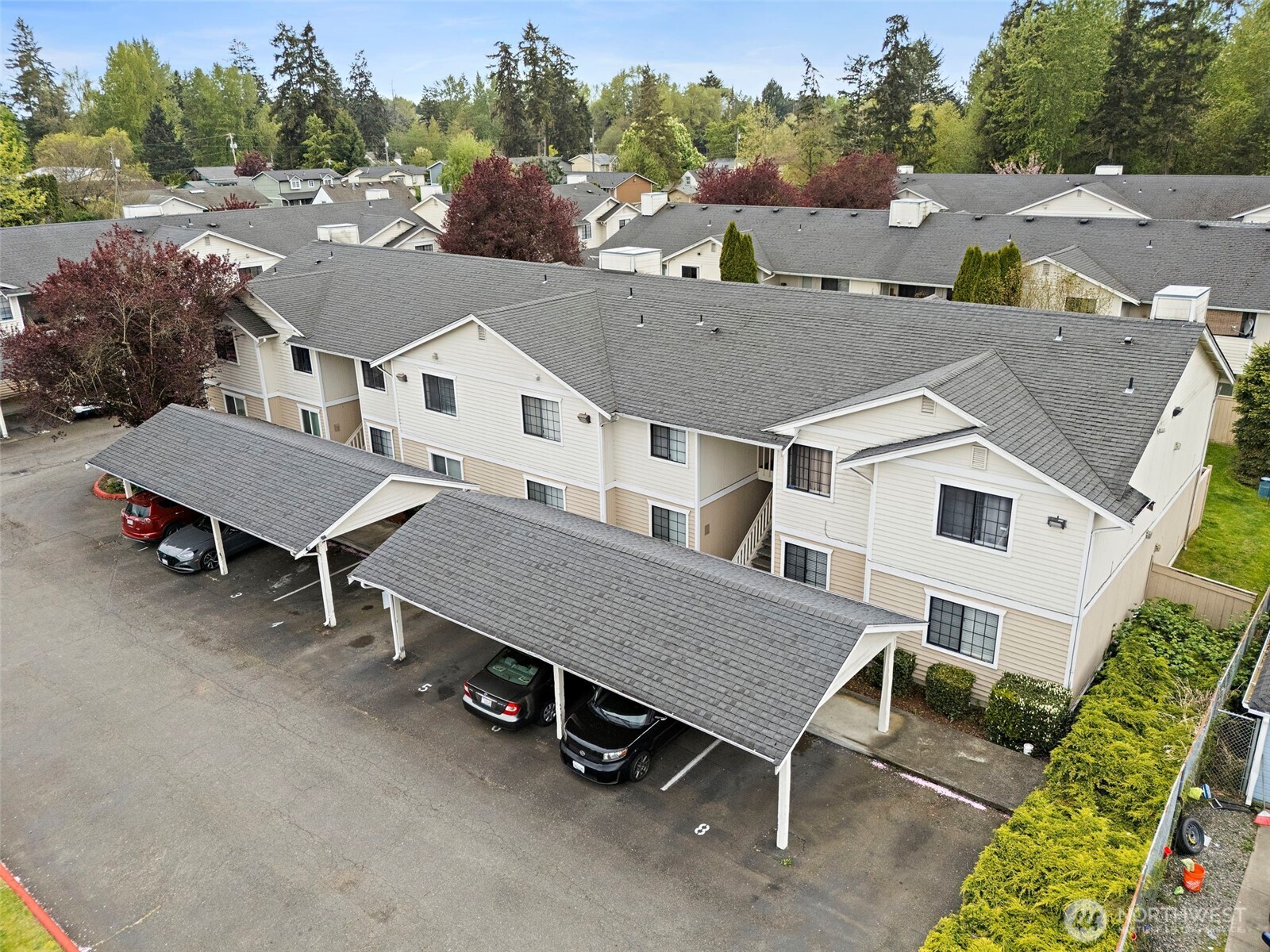 10010 Golden Given Road East, Unit 4 Tacoma, WA 98445 - Photo 1 of 19 an aerial view of a house with a yard and sitting area