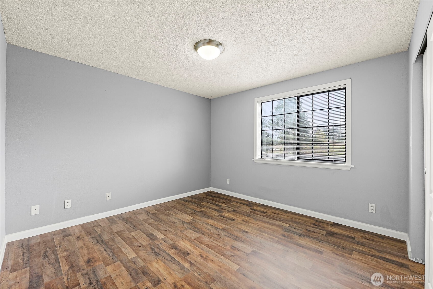 10010 Golden Given Road East, Unit 4 Tacoma, WA 98445 - Photo 11 of 19 an empty room with windows