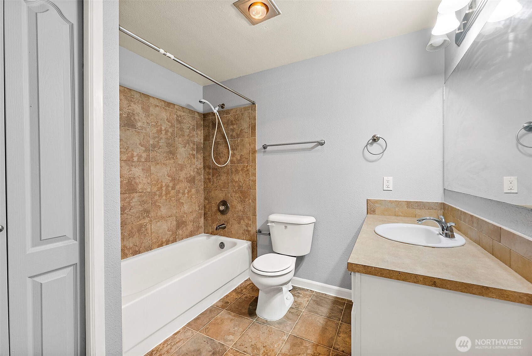10010 Golden Given Road East, Unit 4 Tacoma, WA 98445 - Photo 13 of 19 a bathroom with a sink toilet and shower