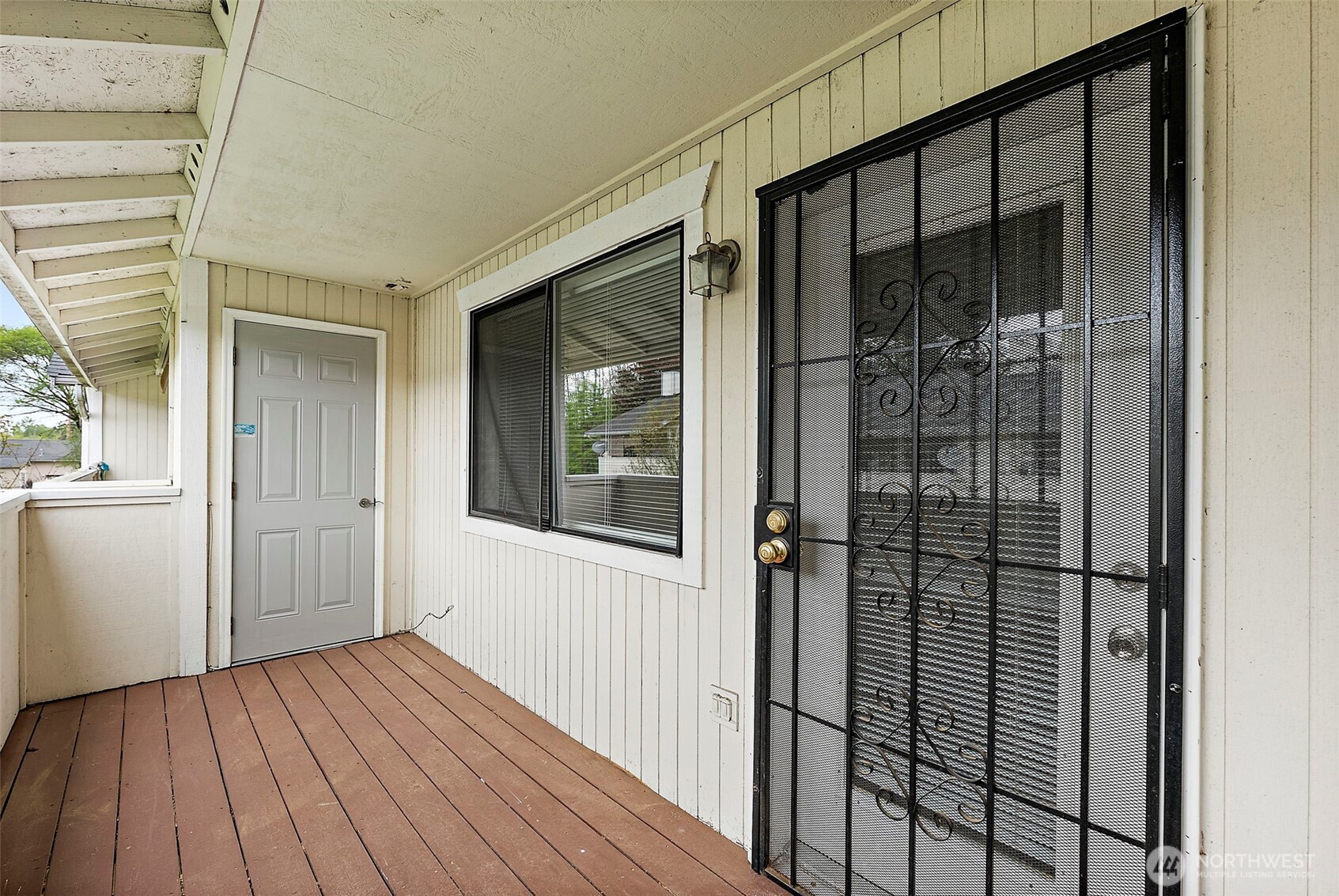 10010 Golden Given Road East, Unit 4 Tacoma, WA 98445 - Photo 15 of 19 a view of a porch with wooden floor and a gate