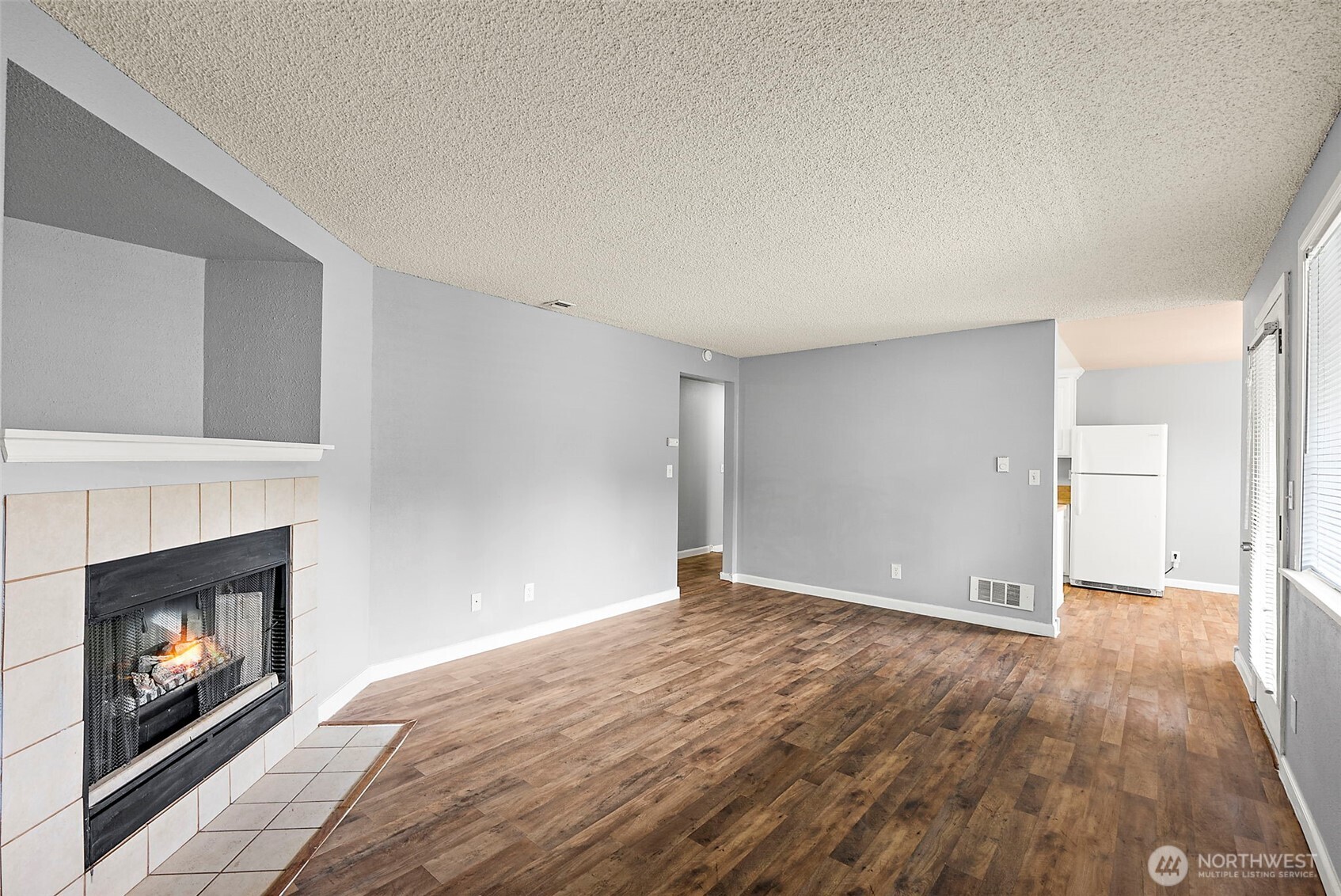 10010 Golden Given Road East, Unit 4 Tacoma, WA 98445 - Photo 7 of 19 a view of an empty room and fire place