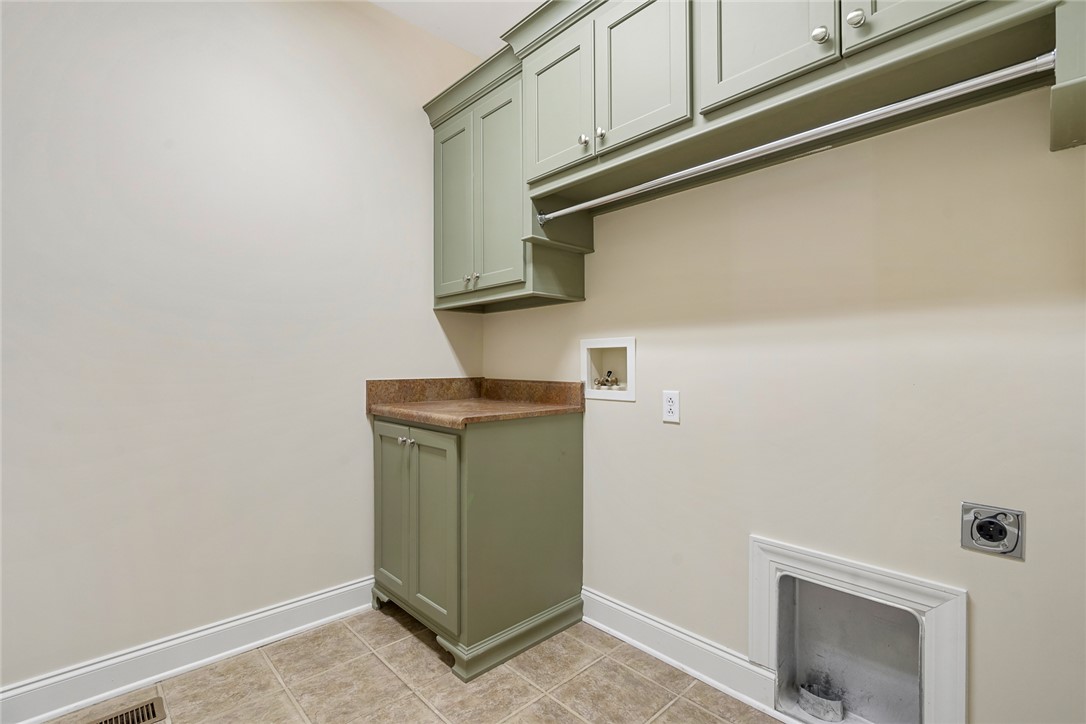 16 Oleander Drive Anderson, SC 29621 - Photo 32 of 37 Ample storage and a convenient hanging rod define this functional laundry room.