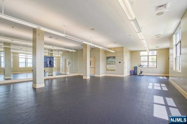 26 Ave At Port Imperial, Unit 307 West New York, NJ 07093 - Photo 13 of 25 an empty room with wooden floor and windows