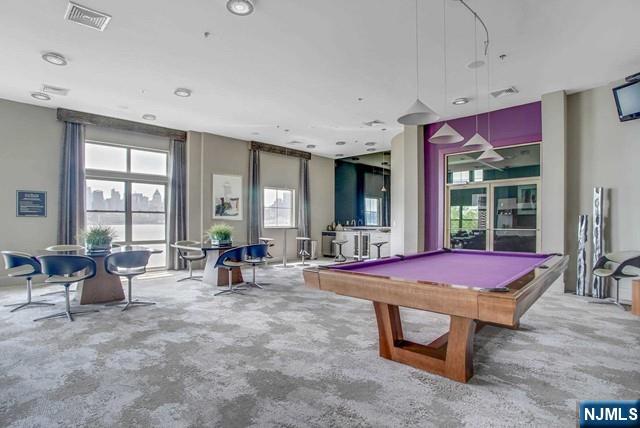 26 Ave At Port Imperial, Unit 307 West New York, NJ 07093 - Photo 16 of 25 a living room with furniture a rug and large windows