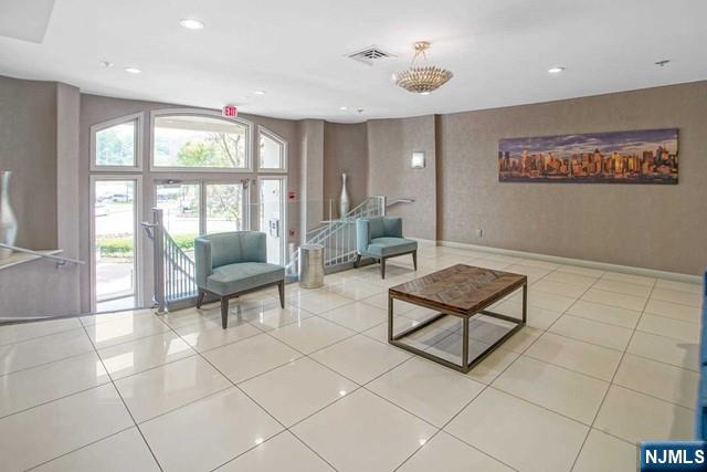 26 Ave At Port Imperial, Unit 307 West New York, NJ 07093 - Photo 2 of 25 a living room with furniture and a floor to ceiling window