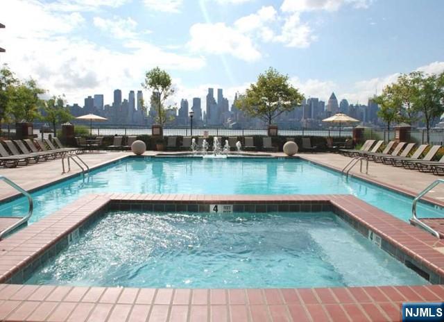 26 Ave At Port Imperial, Unit 307 West New York, NJ 07093 - Photo 21 of 25 a view of a swimming pool with outdoor seating
