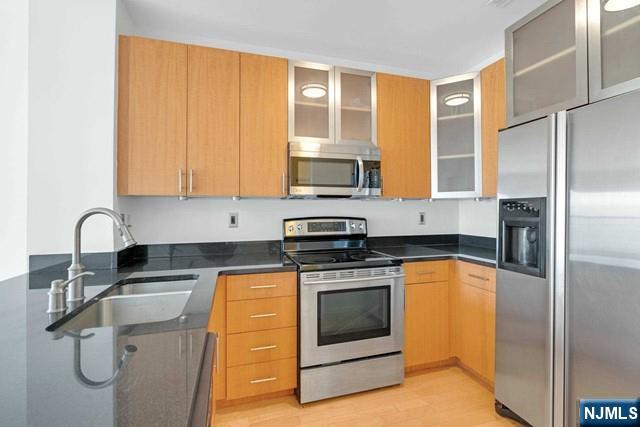 26 Ave At Port Imperial, Unit 307 West New York, NJ 07093 - Photo 4 of 25 a kitchen with stainless steel appliances granite countertop a stove a sink and a refrigerator