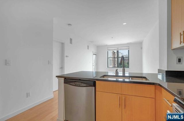 26 Ave At Port Imperial, Unit 307 West New York, NJ 07093 - Photo 5 of 25 a kitchen with stainless steel appliances granite countertop a sink and a white cabinets
