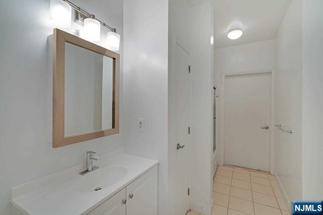 26 Ave At Port Imperial, Unit 307 West New York, NJ 07093 - Photo 8 of 25 a bathroom with a sink a toilet and mirror