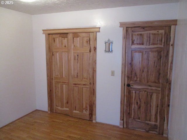 558 East Fulton Street Union, OR 97883 - Photo 11 of 41 an empty room with wooden floor closet and windows