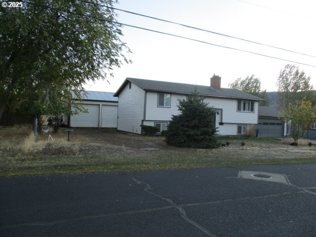 558 East Fulton Street Union, OR 97883 - Photo 20 of 41 a front view of a house with a garden and tree