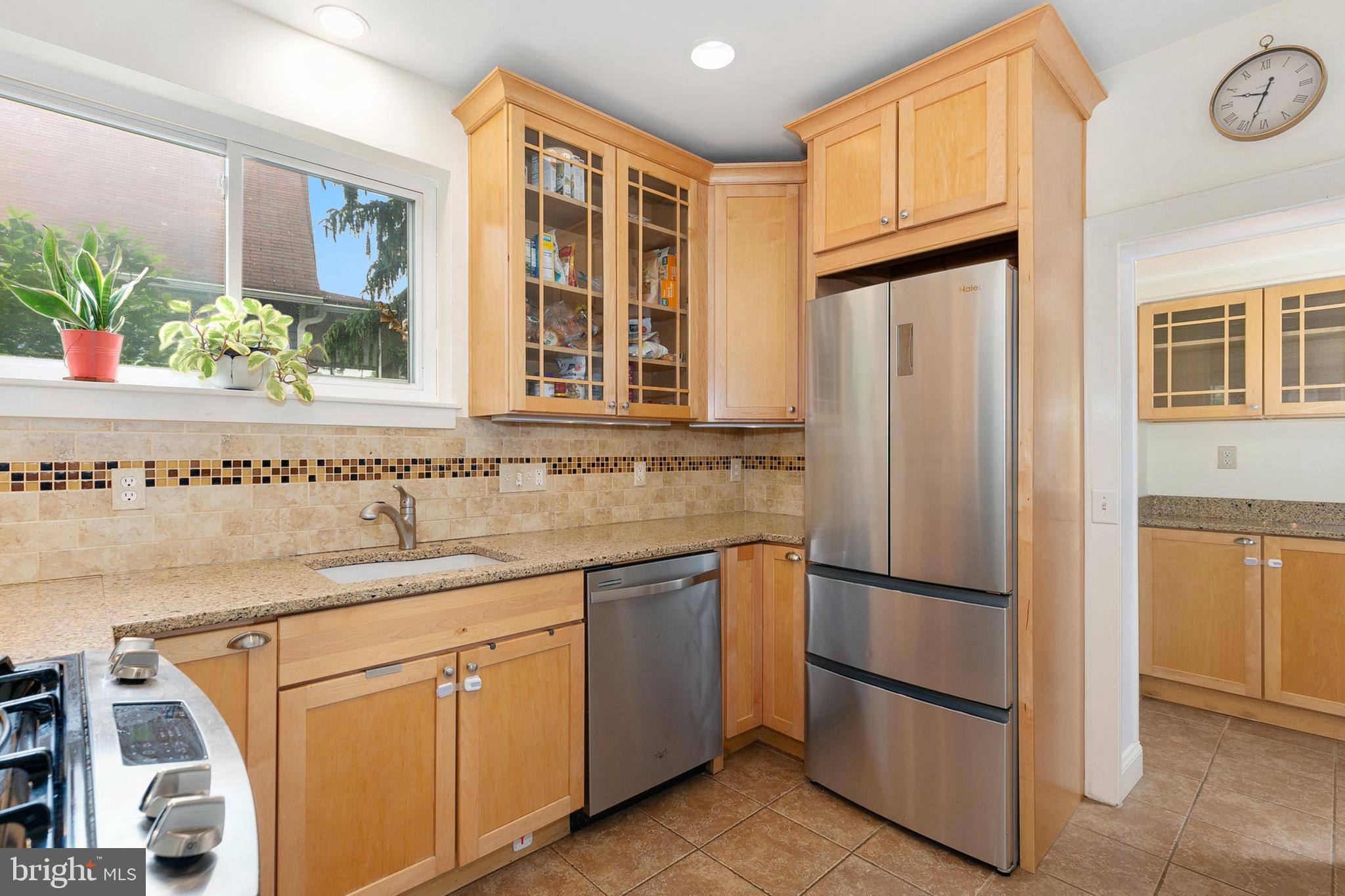 8601 Mayfair Place Silver Spring, MD 20910 - Photo 19 of 63 a kitchen with stainless steel appliances granite countertop a refrigerator and a sink