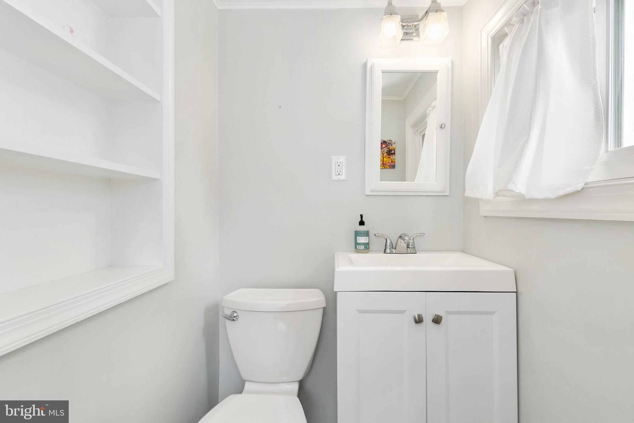 8601 Mayfair Place Silver Spring, MD 20910 - Photo 24 of 63 a bathroom with a toilet sink and mirror