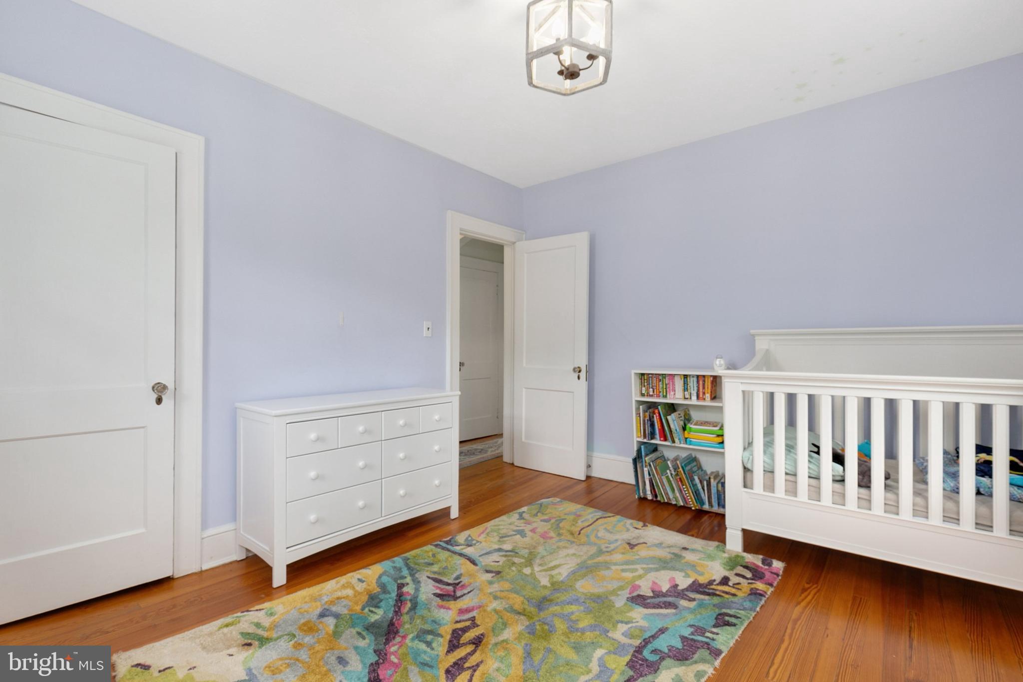 8601 Mayfair Place Silver Spring, MD 20910 - Photo 27 of 63 a bedroom with a bed and wooden floor