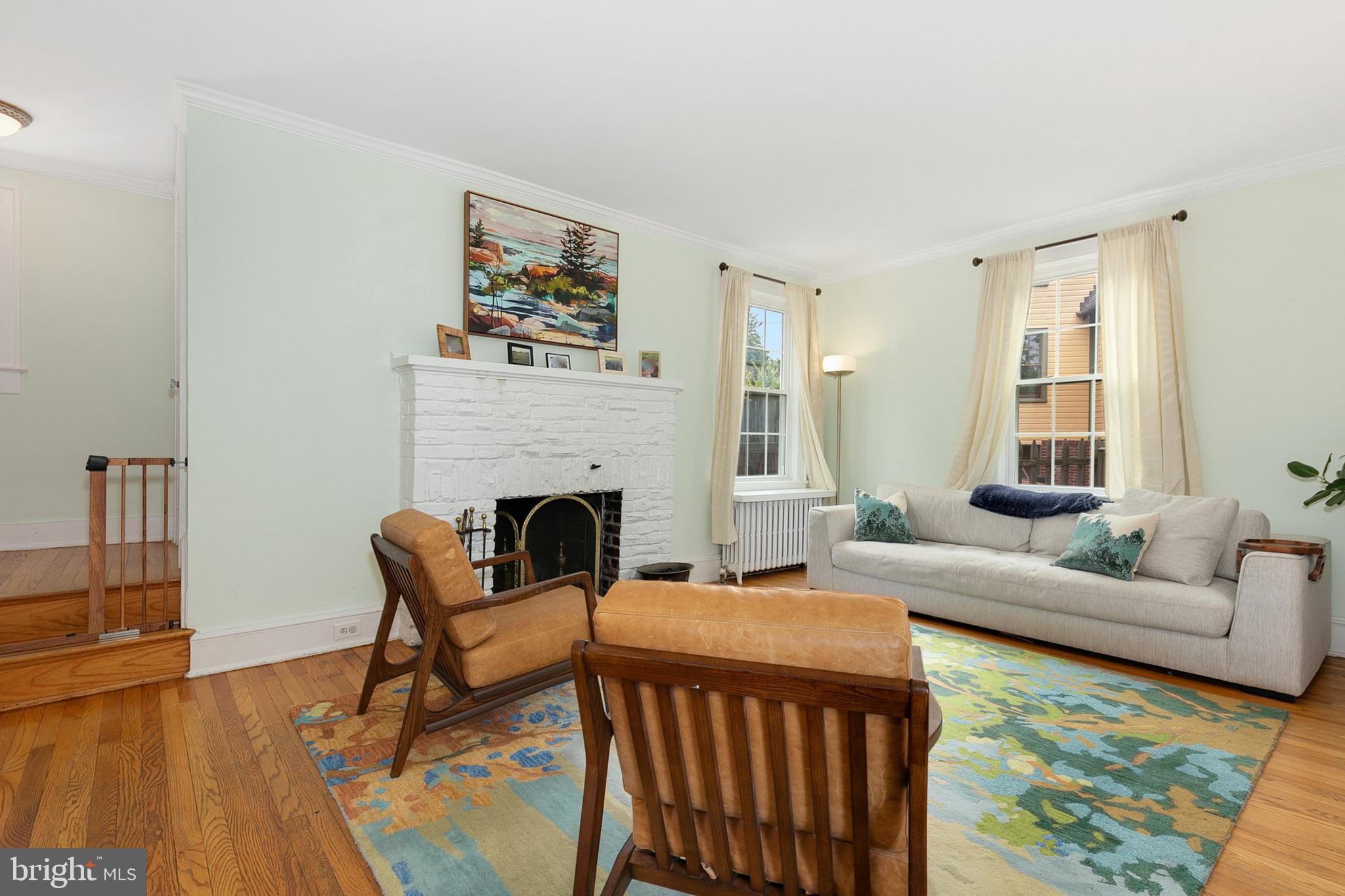 8601 Mayfair Place Silver Spring, MD 20910 - Photo 8 of 63 a living room with furniture a fireplace and a table