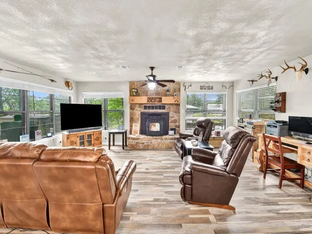 a living room with fireplace furniture and a flat screen tv
