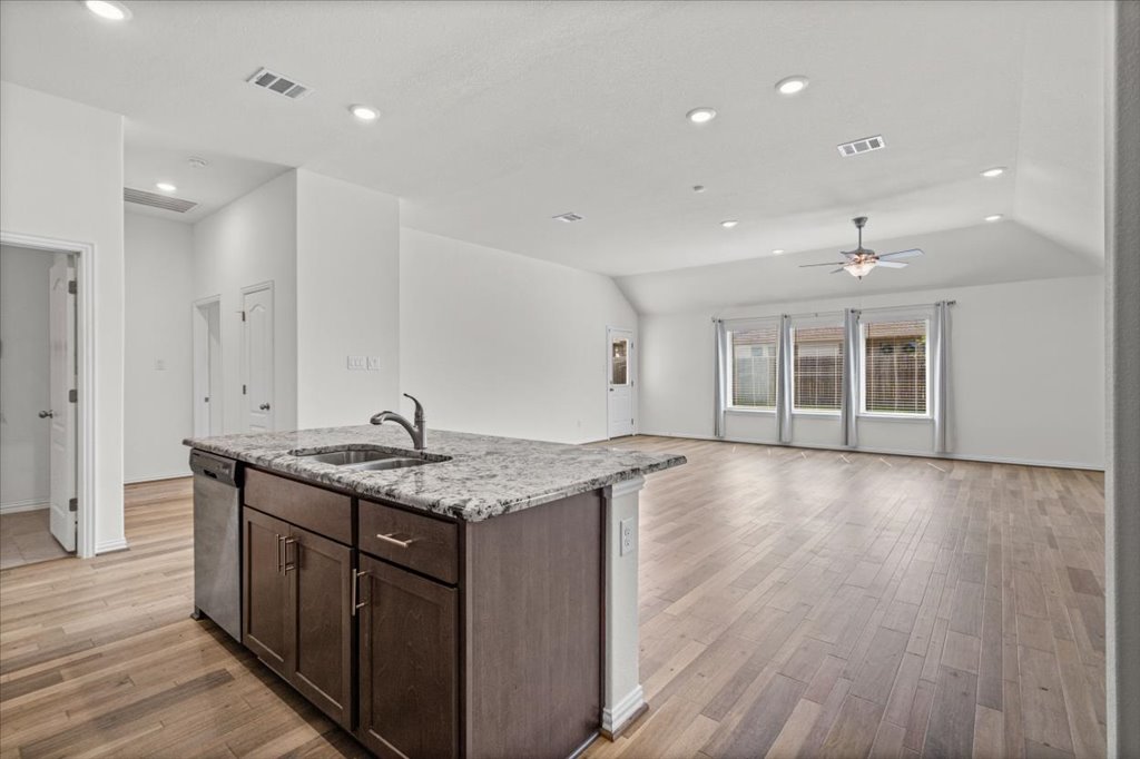 277 Spinnaker Loop Kyle, TX 78640 - Photo 13 of 38 A grand, open-concept living space with sleek flooring and ample natural illumination awaits.