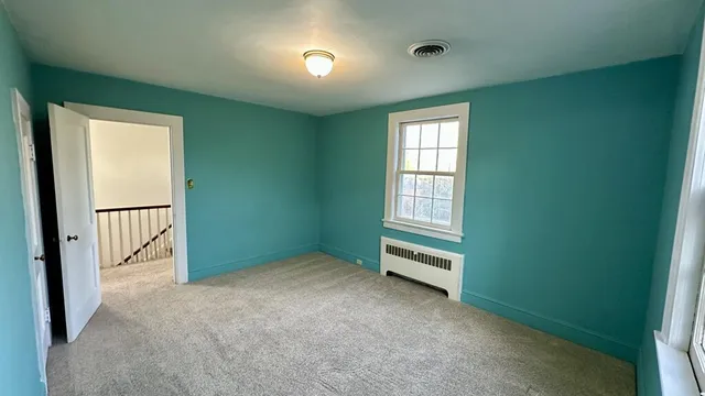 an empty room with windows and closet