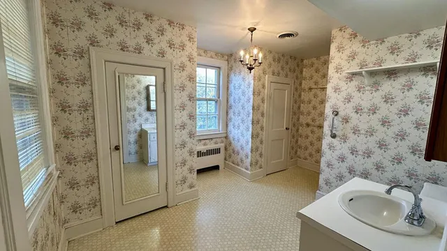 a bathroom with a tub sink and mirror